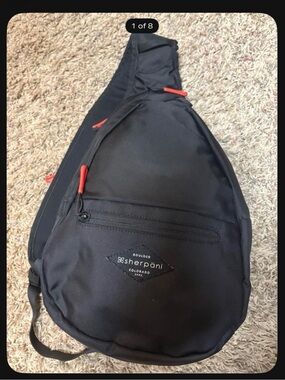 Sherpani Black Sling Bag with Red Accents